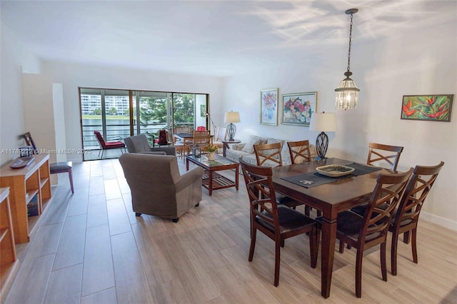 2751 N Palm Aire Dr Unit 310, Pompano Beach, FL 33069 - dining room with a chandelier and light wood finished floors