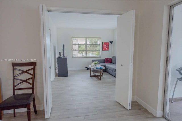 2751 N Palm Aire Dr Unit 310, Pompano Beach, FL 33069 - corridor featuring baseboards and light wood finished floors