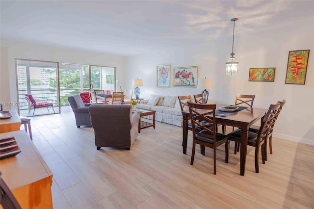 2751 N Palm Aire Dr Unit 310, Pompano Beach, FL 33069 - dining area with light wood-type flooring and a chandelier