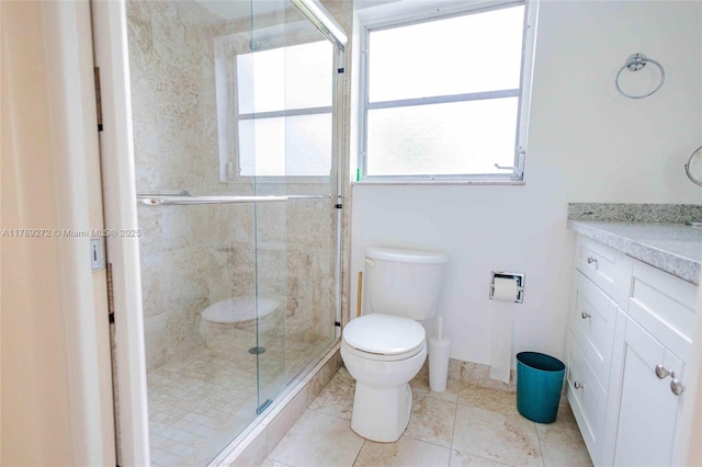 2751 N Palm Aire Dr Unit 310, Pompano Beach, FL 33069 - bathroom featuring toilet, vanity, a stall shower, and healthy amount of natural light