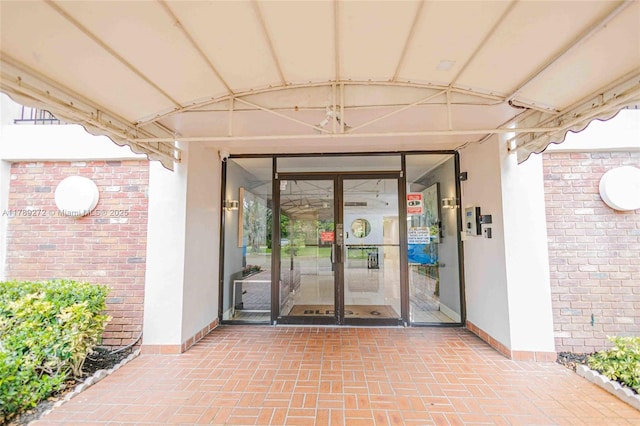 2751 N Palm Aire Dr Unit 310, Pompano Beach, FL 33069 - doorway to property with brick siding and stucco siding