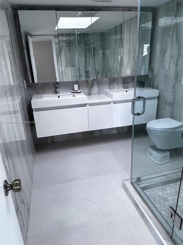 3811 NE 166th St Unit 3, North Miami Beach, FL 33160 - full bathroom featuring double vanity, a sink, a stall shower, and toilet
