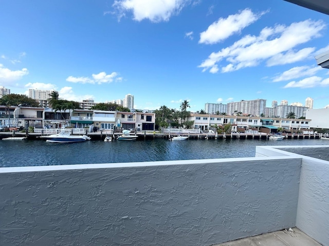 dock area featuring a city view, a water view, and a balcony