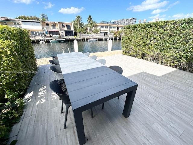 view of dock featuring a water view and outdoor dining space