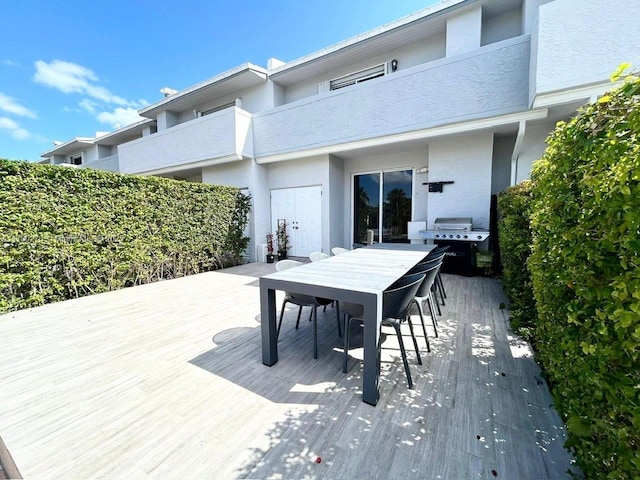 view of patio / terrace featuring grilling area, outdoor dining area, and a balcony