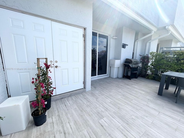 doorway to property featuring stucco siding