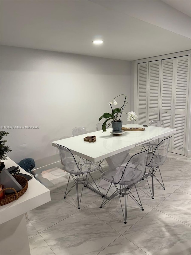dining space with recessed lighting and baseboards
