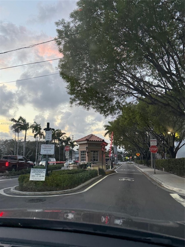 view of street with traffic signs and curbs