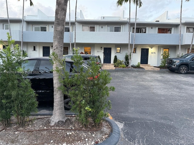 view of property with uncovered parking