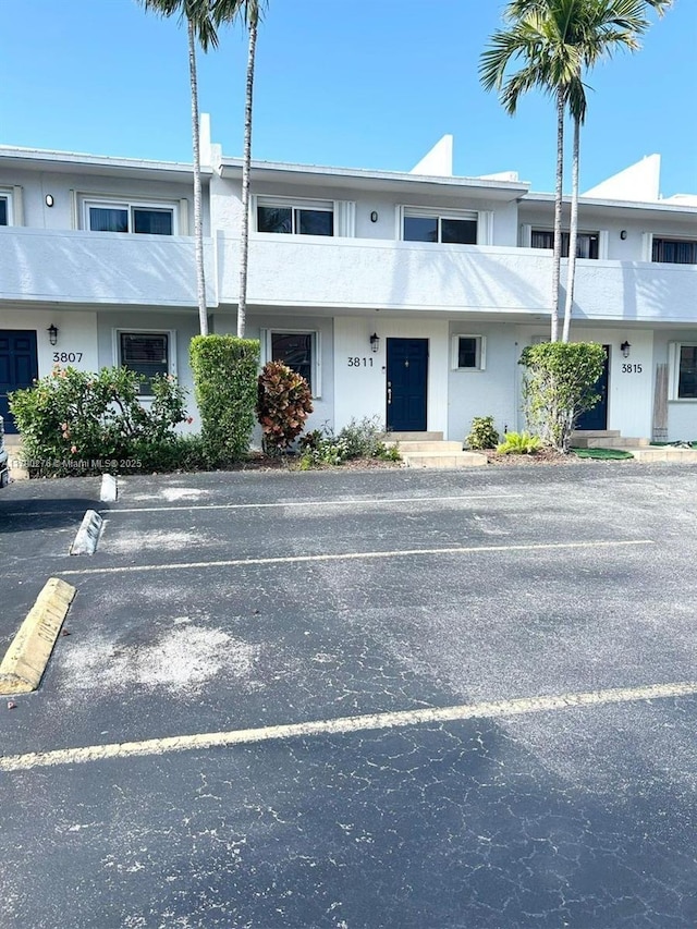 view of property featuring uncovered parking
