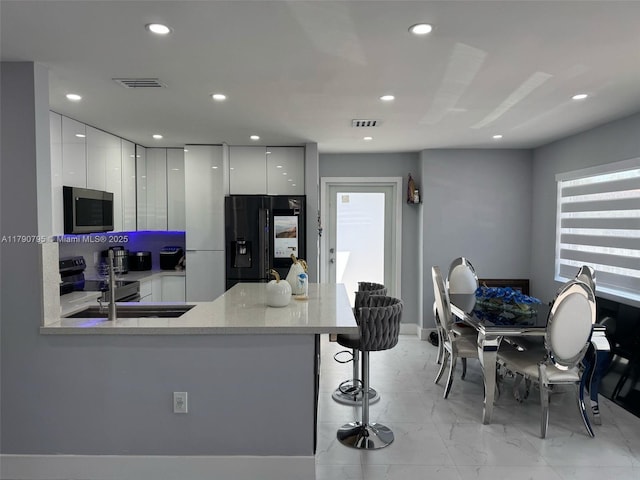 729 E 23rd St, Hialeah, FL 33013 - kitchen with modern cabinets, stainless steel appliances, and recessed lighting