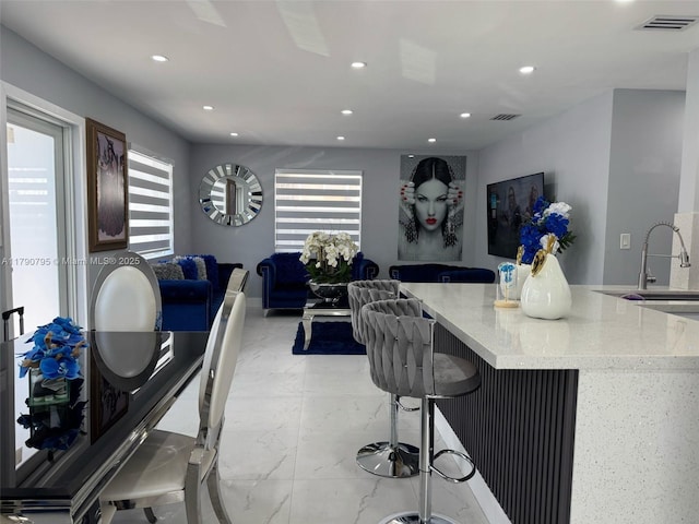 729 E 23rd St, Hialeah, FL 33013 - kitchen with recessed lighting, visible vents, light stone counters, and marble finish floor
