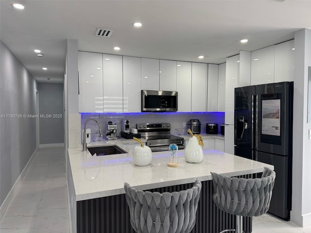 729 E 23rd St, Hialeah, FL 33013 - kitchen with a sink, modern cabinets, stainless steel appliances, and marble finish floor