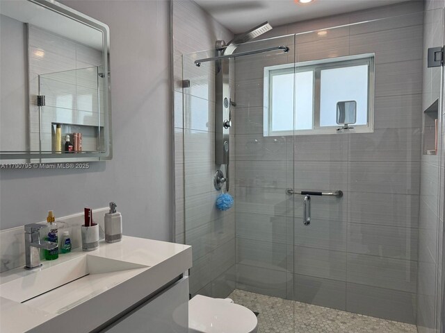 729 E 23rd St, Hialeah, FL 33013 - full bath with vanity, toilet, a ceiling fan, and a stall shower