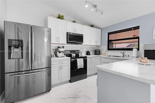 14712 SW 84th Ter, Miami, FL 33193 - kitchen featuring appliances with stainless steel finishes, vaulted ceiling, light marble finish flooring, backsplash, and light countertops