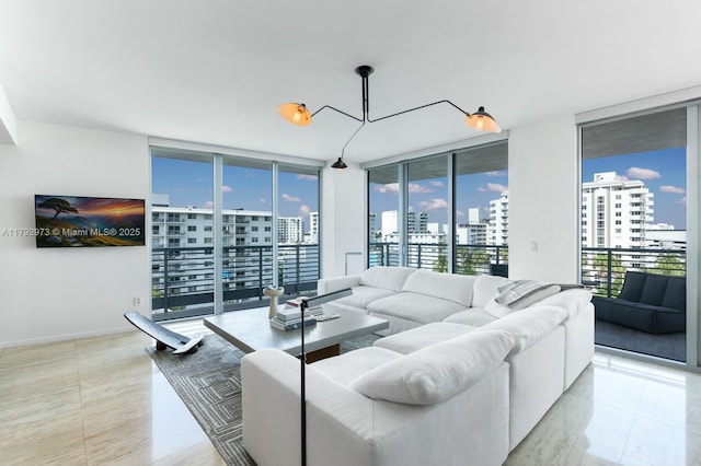 living area with baseboards, a city view, floor to ceiling windows, and a notable chandelier