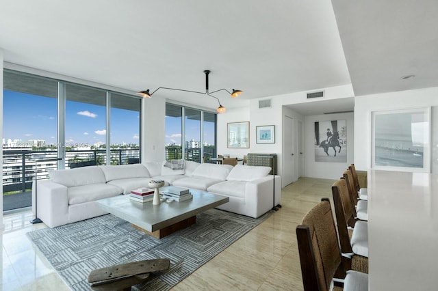living area with a view of city, visible vents, and expansive windows