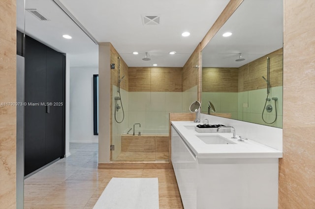 full bathroom with visible vents, a sink, a stall shower, and recessed lighting