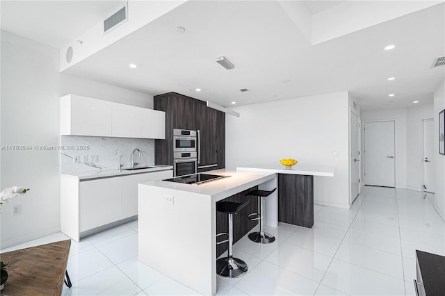 851 NE 1st Ave Unit 2604, Miami, FL 33132 - kitchen with modern cabinets, black electric cooktop, recessed lighting, white cabinets, and decorative backsplash