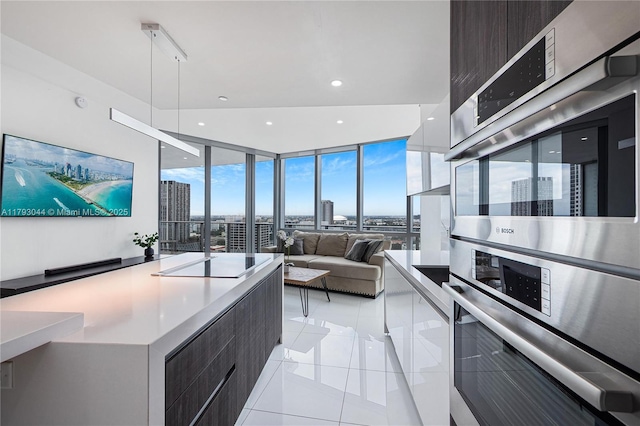851 NE 1st Ave Unit 2604, Miami, FL 33132 - kitchen featuring modern cabinets, light tile patterned flooring, expansive windows, a view of city, and recessed lighting