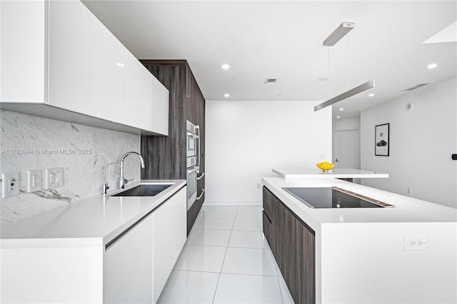 851 NE 1st Ave Unit 2604, Miami, FL 33132 - kitchen with modern cabinets, white cabinetry, black electric cooktop, a kitchen island, and recessed lighting