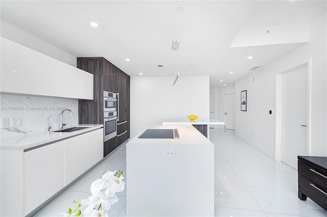 851 NE 1st Ave Unit 2604, Miami, FL 33132 - kitchen featuring black electric cooktop, modern cabinets, white cabinetry, recessed lighting, and light countertops