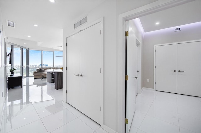 851 NE 1st Ave Unit 2604, Miami, FL 33132 - hall with a wall of windows, recessed lighting, and light tile patterned floors