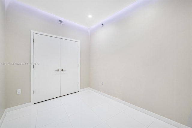 851 NE 1st Ave Unit 2604, Miami, FL 33132 - unfurnished bedroom featuring a closet, light tile patterned floors, and recessed lighting