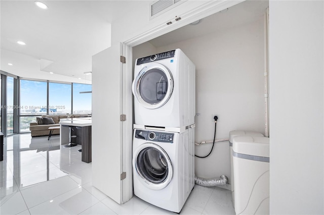 851 NE 1st Ave Unit 2604, Miami, FL 33132 - laundry room with stacked washing machine and dryer, recessed lighting, and light tile patterned floors