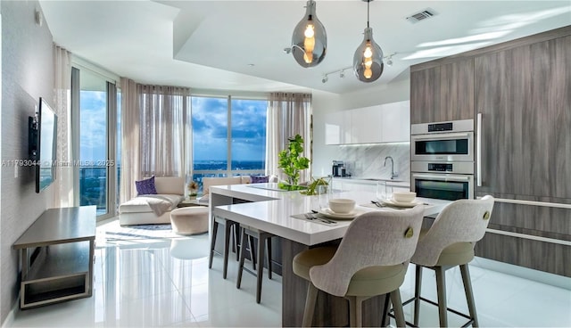 851 NE 1st Ave Unit 2604, Miami, FL 33132 - dining space featuring floor to ceiling windows and light tile patterned floors