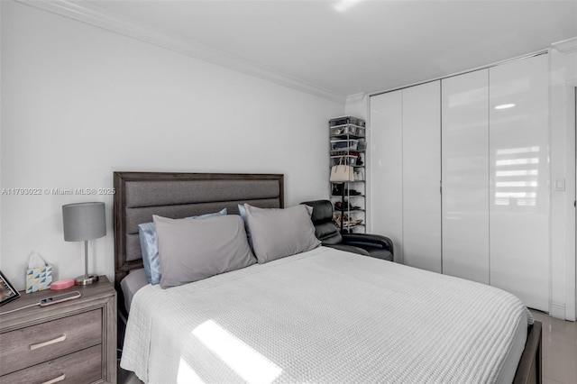 bedroom with crown molding and a closet