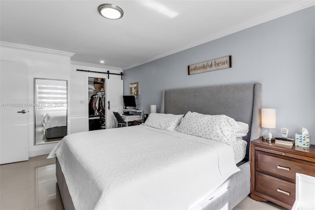 bedroom with crown molding, a closet, and a barn door