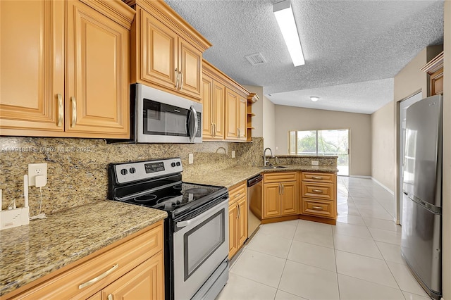 kitchen featuring appliances with stainless steel finishes, backsplash, a peninsula, and visible vents