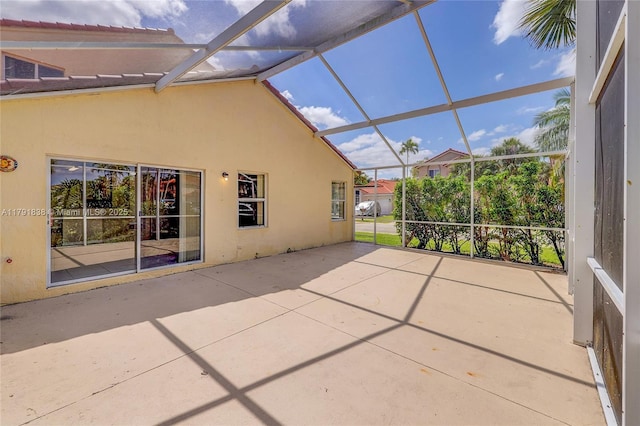 view of patio / terrace featuring glass enclosure