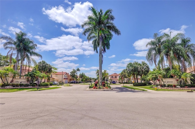 view of road with a residential view, sidewalks, and curbs