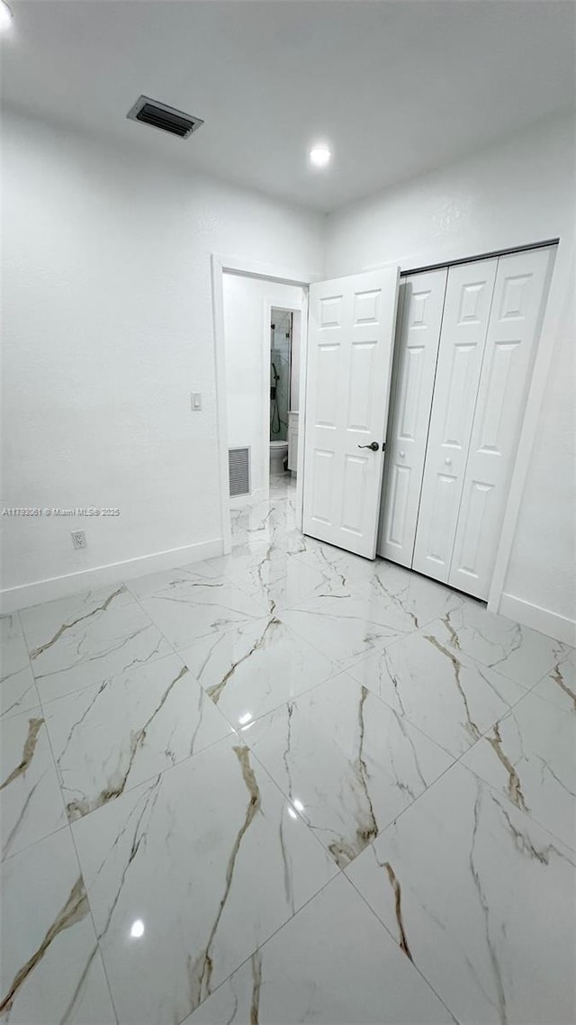 unfurnished room featuring baseboards, recessed lighting, marble finish floor, and visible vents