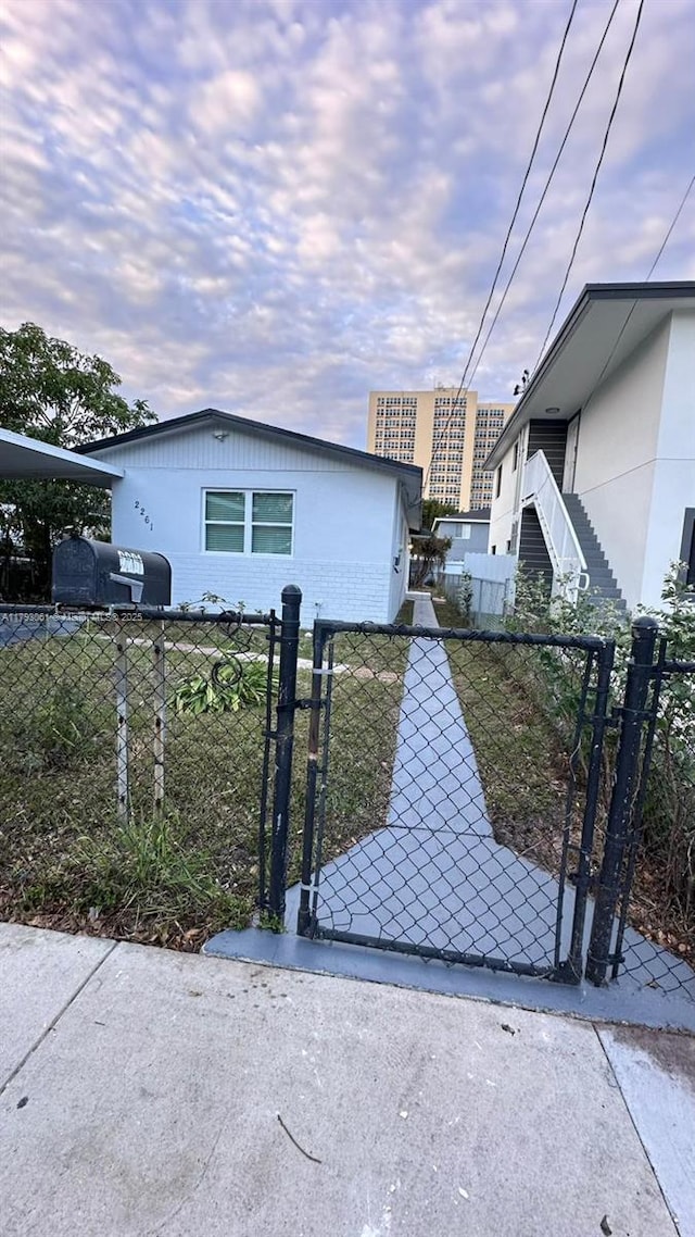 view of front of home featuring fence private yard and a gate