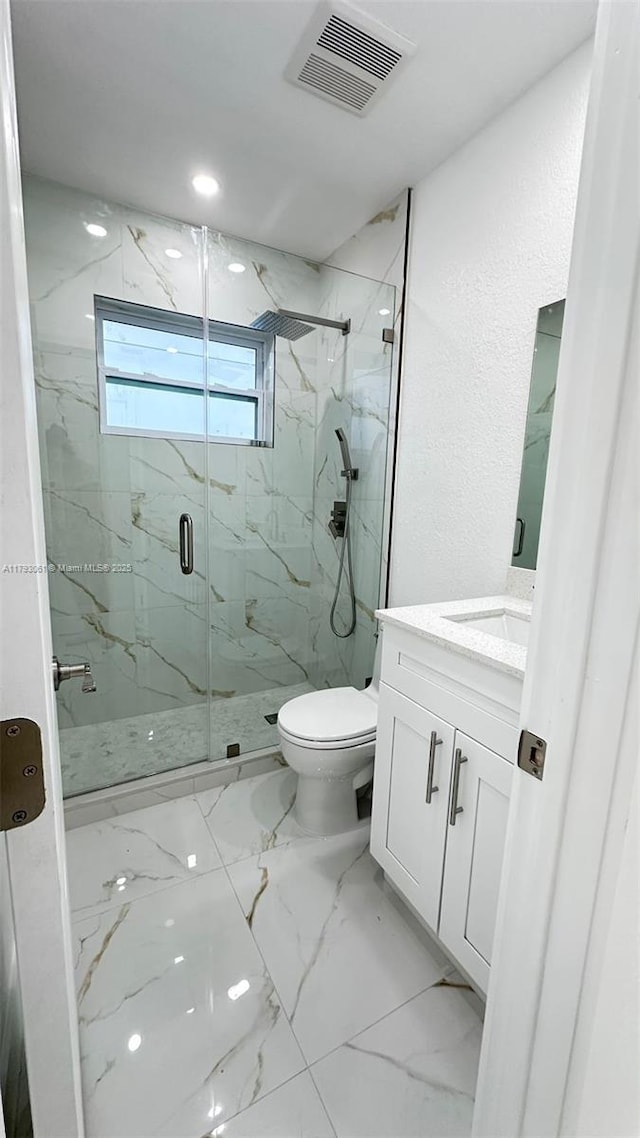 bathroom with visible vents, vanity, marble finish floor, toilet, and a marble finish shower