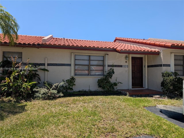 11212 SW 58th Cir, Cooper City, FL 33330 - mediterranean / spanish house with stucco siding, a tile roof, and a front yard