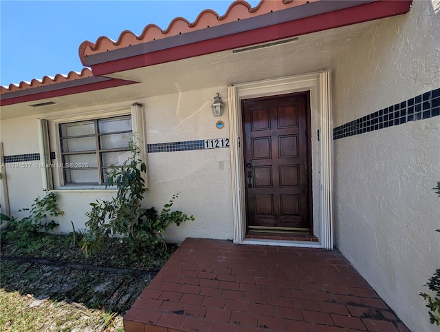 11212 SW 58th Cir, Cooper City, FL 33330 - property entrance with stucco siding and a tiled roof
