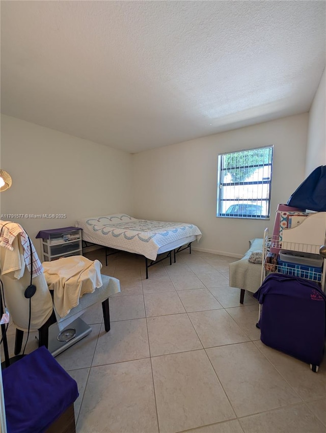 11212 SW 58th Cir, Cooper City, FL 33330 - bedroom with a textured ceiling, tile patterned floors, and baseboards