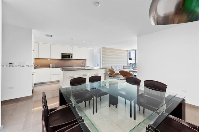 68 SE 6th St Unit 3703, Miami, FL 33131 - dining room with baseboards and light tile patterned floors