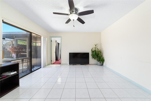 720 7th Ln, Green Acres, FL 33463 - unfurnished living room with baseboards, a textured ceiling, ceiling fan, and light tile patterned flooring