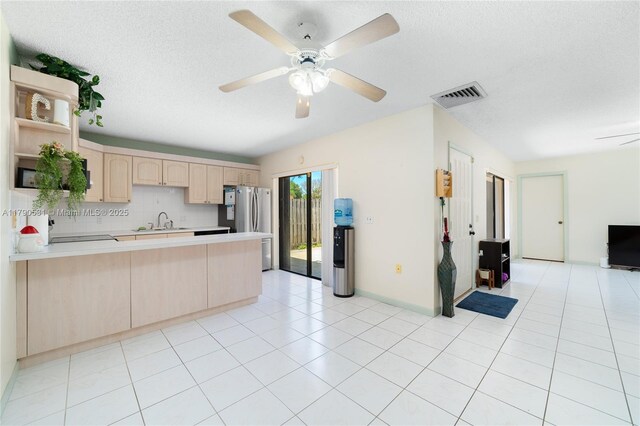 720 7th Ln, Green Acres, FL 33463 - kitchen with open shelves, a sink, freestanding refrigerator, a peninsula, and visible vents