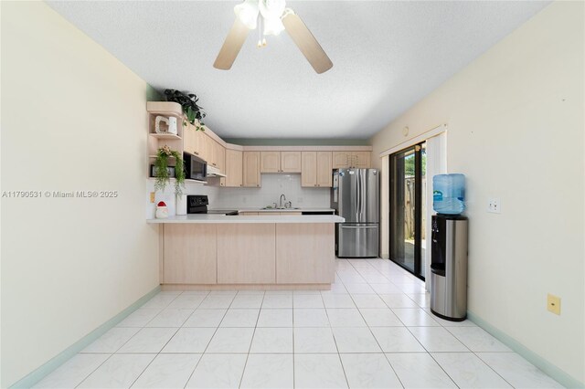 720 7th Ln, Green Acres, FL 33463 - kitchen with freestanding refrigerator, a peninsula, light brown cabinetry, black range with electric stovetop, and a sink