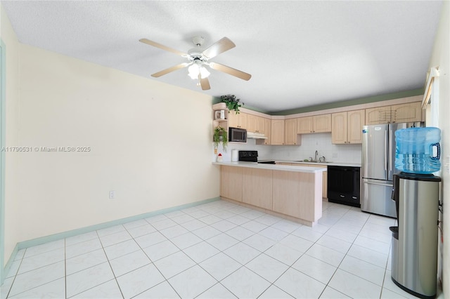 720 7th Ln, Green Acres, FL 33463 - kitchen featuring a peninsula, light brown cabinets, light countertops, a ceiling fan, and black appliances