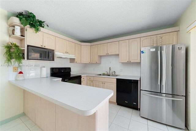 720 7th Ln, Green Acres, FL 33463 - kitchen featuring light brown cabinets, light countertops, under cabinet range hood, a sink, and black appliances