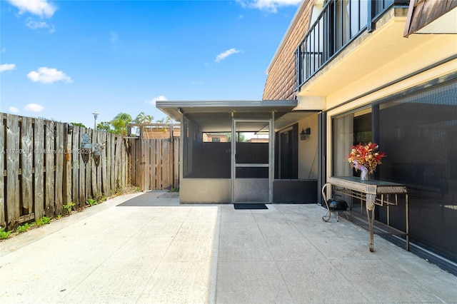 720 7th Ln, Green Acres, FL 33463 - view of patio with fence and a sunroom