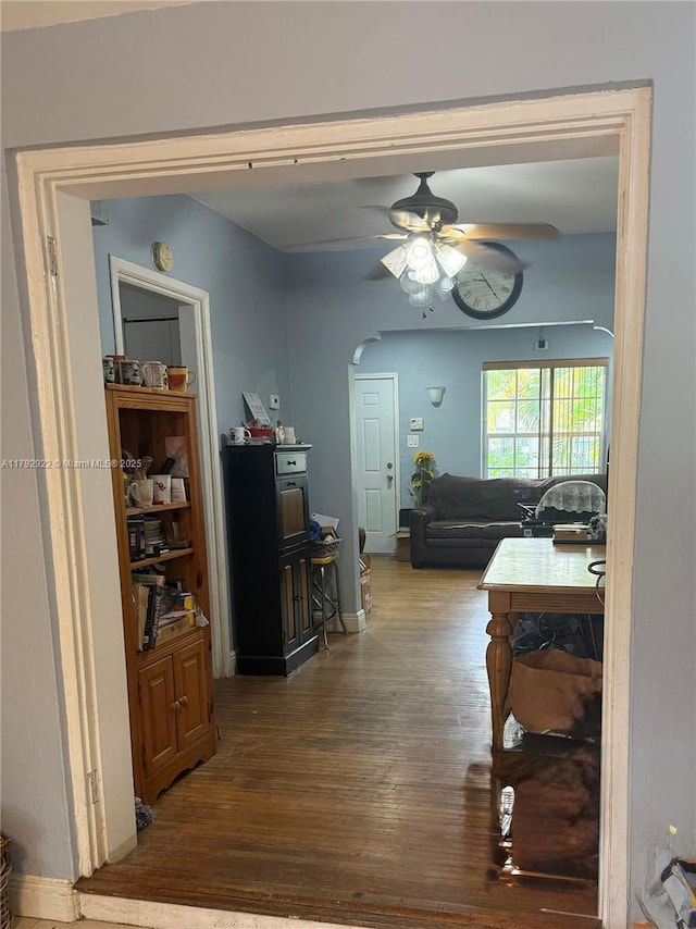 40 NE 49th St, Miami, FL 33137 - dining area featuring ceiling fan, wood finished floors, arched walkways, and baseboards