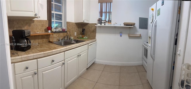 40 NE 49th St, Miami, FL 33137 - kitchen with a sink, white appliances, white cabinetry, and tasteful backsplash